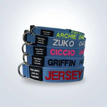 personalised sky blue pet collars stacked vertically on a light gray background. 